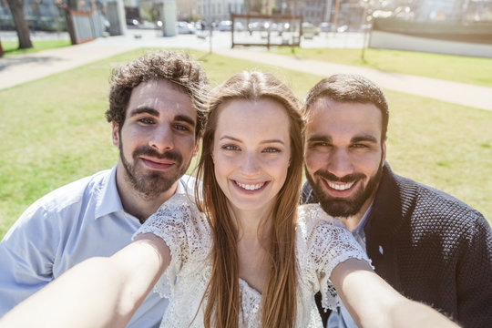 Selfie. A group of three friends taking a picture at the park