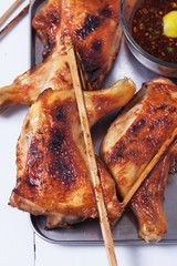 thai grilled chicken with spicy sauce on tray