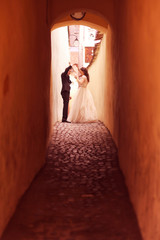 Bride and groom on narrow street