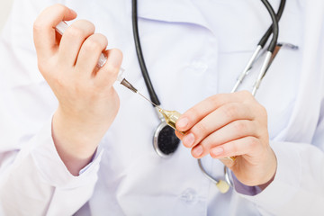 nurse fills syringe from vial