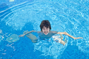 Happy teen in the swimming pool