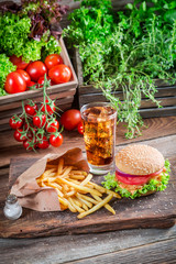 Fresh hamburger with cold drink and fries