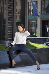 Beautiful business woman sitting on a bench