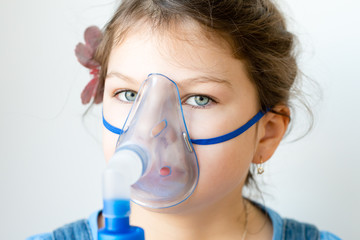 girl with asthma / allergy inhaler - inhalation mask