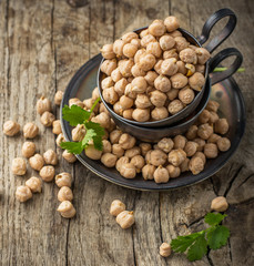 Vintage silver cup filled with dry chickpeas on