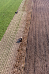Fototapeta premium aerial view of harvest fields with tractor