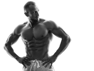Young muscular guy on white background