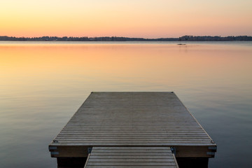 Wooden pier in the Scandinavian evening lake