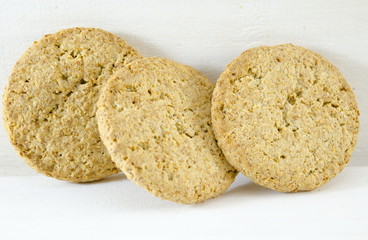 Integral cookies and wheat on white background