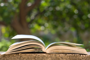 Open book with flipped pages outdoor.