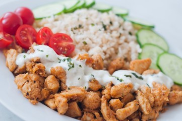 Gyros chicken with rice, tzatziki dressing and vegetables