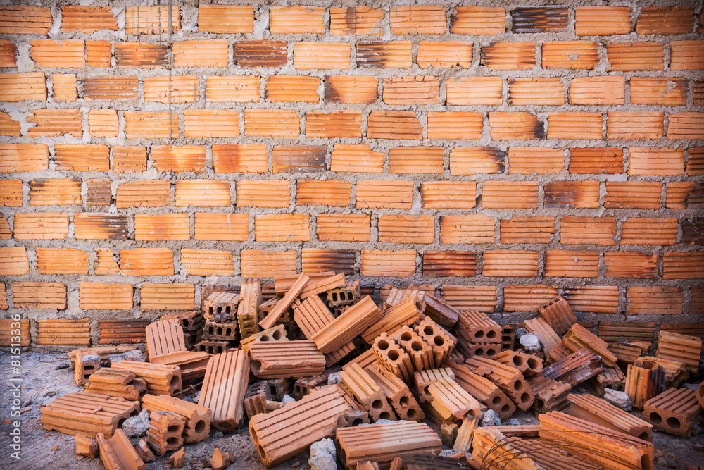 Canvas Prints pile of bricks in construction site with brick wall background