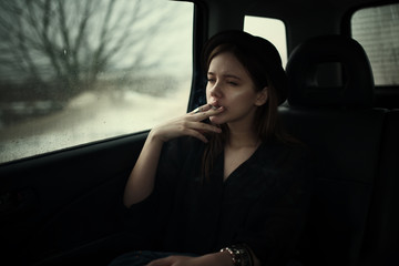 portrait of a beautiful sad girl in the car