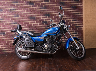 Obraz na płótnie Canvas Blue motorbike parked indoors