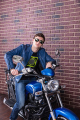 Obraz na płótnie Canvas Cool dude sitting on his motorbike