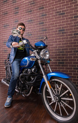 Obraz na płótnie Canvas Young Man in Trendy Fashion on his Motorbike