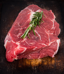 Raw beef steak on wooden table