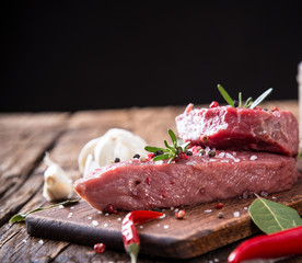 Raw beef steak on wooden table