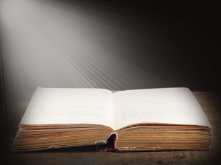 Book illuminated by bright beam of light