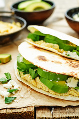 tortilla with hummus, avocado, feta and parsley