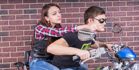 Fototapeta na wymiar Close up Young White Couple Riding a Motorcycle