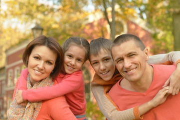 Family relaxing in autumn park