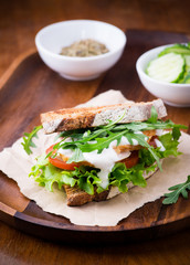 Rye toast sandwich with green leaf, tomato and chicken