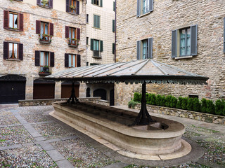 Fototapeta na wymiar Public medieval laudry in Bergamo square