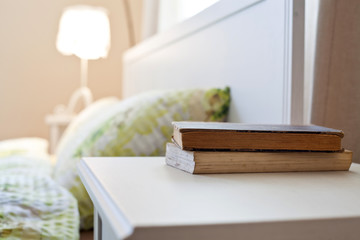 Fototapeta premium bedroom with books on nightstand