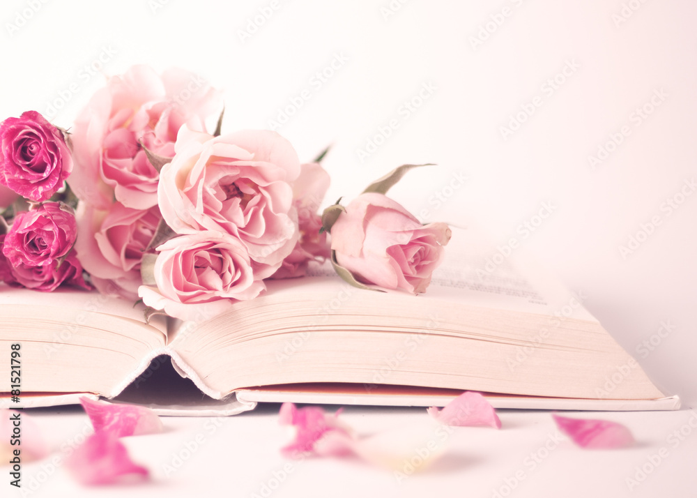 Wall mural Vintage pink peonies on top of a book over beige background