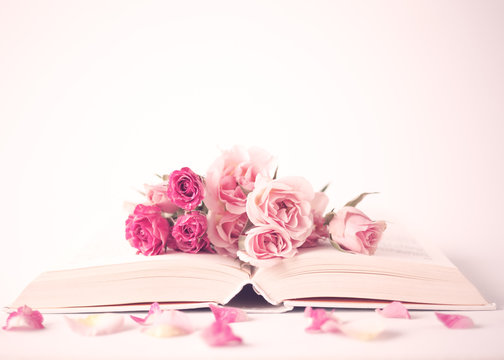 Fototapeta Vintage pink peonies over book over beige background