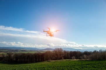 Fototapeta na wymiar Small drone above the field