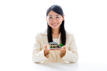asian businesswoman with miniature house