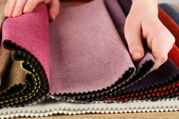 Woman chooses scraps of colored tissue on table close up