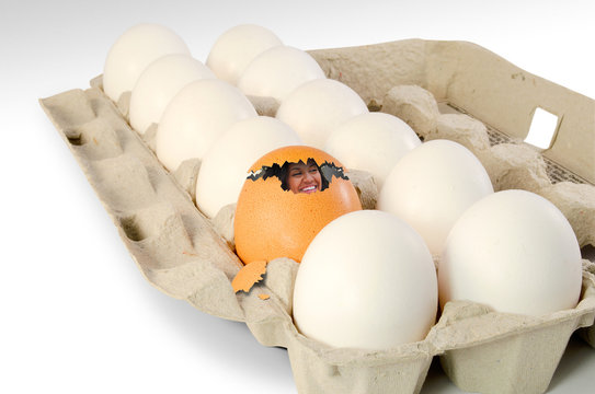 Humorous image of a woman breaking out of an egg shell.