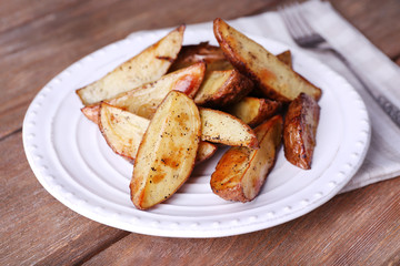 Baked potatoes on pate on wooden table