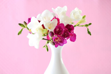 Beautiful spring flowers on pink background