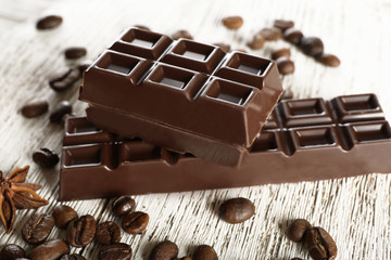Stuffed chocolate with coffee beans on wooden table, closeup