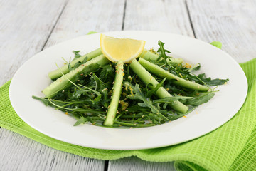 Plate of green salad with cucumber, arugula and rosemary