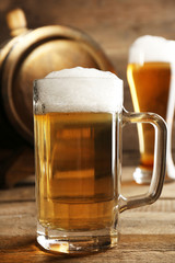 Glasses of beer on wooden background