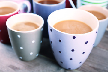 Cups of cappuccino on wooden table, closeup