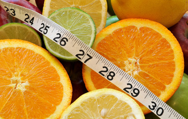 Healthy food choices - measuring tape and fruit