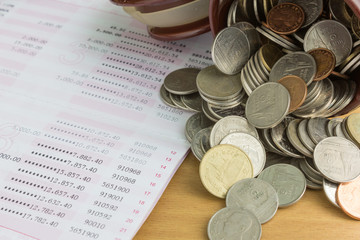 pile of  thai coins with passbook
