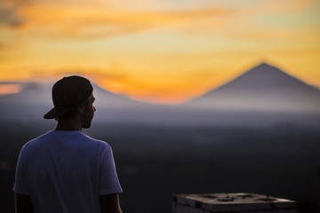 Man and Volcano Agung as Background.