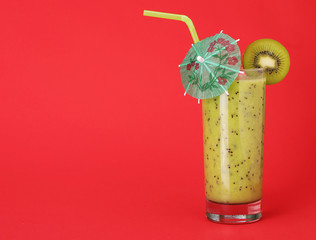 healthy glass of smoothies kiwi flavor on red background