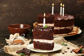 Fototapeta na wymiar Delicious chocolate cake on table on brown background