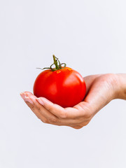 The Girl holding tomato. - Healthy food concept.