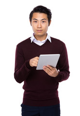 Fototapeta na wymiar Cheerful Asian man using a tablet PC