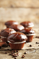 Tasty homemade chocolate muffins on wooden table