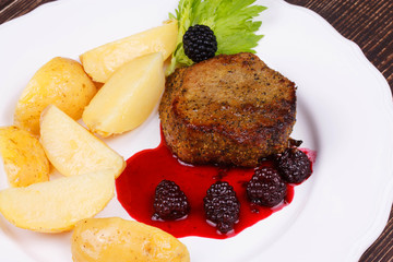 Grilled beef steak with blackberry sauce
